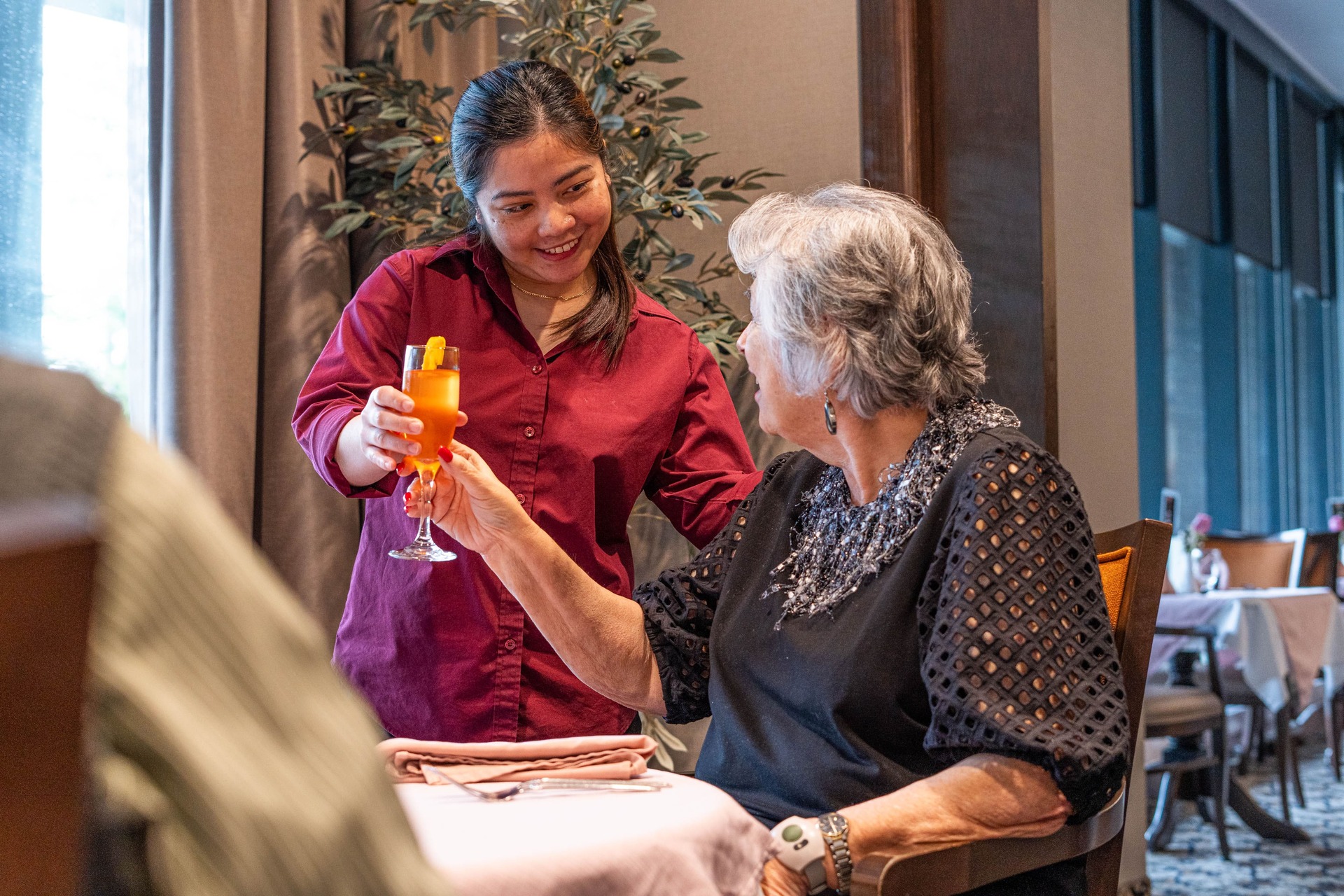 Resident being served a drink at Forestview Retirement Home Facility Toronto North York